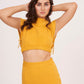 Mustard yellow long skirt with high-waisted design and side slit, made from high-quality muslin fabric. Side cut adds drama and allure. Suitable for dressing up or down.