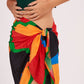 Elegant beach sarong wrap draping over a woman's curves, showcasing its versatile and timeless design, perfect for a beach vacation outfit.