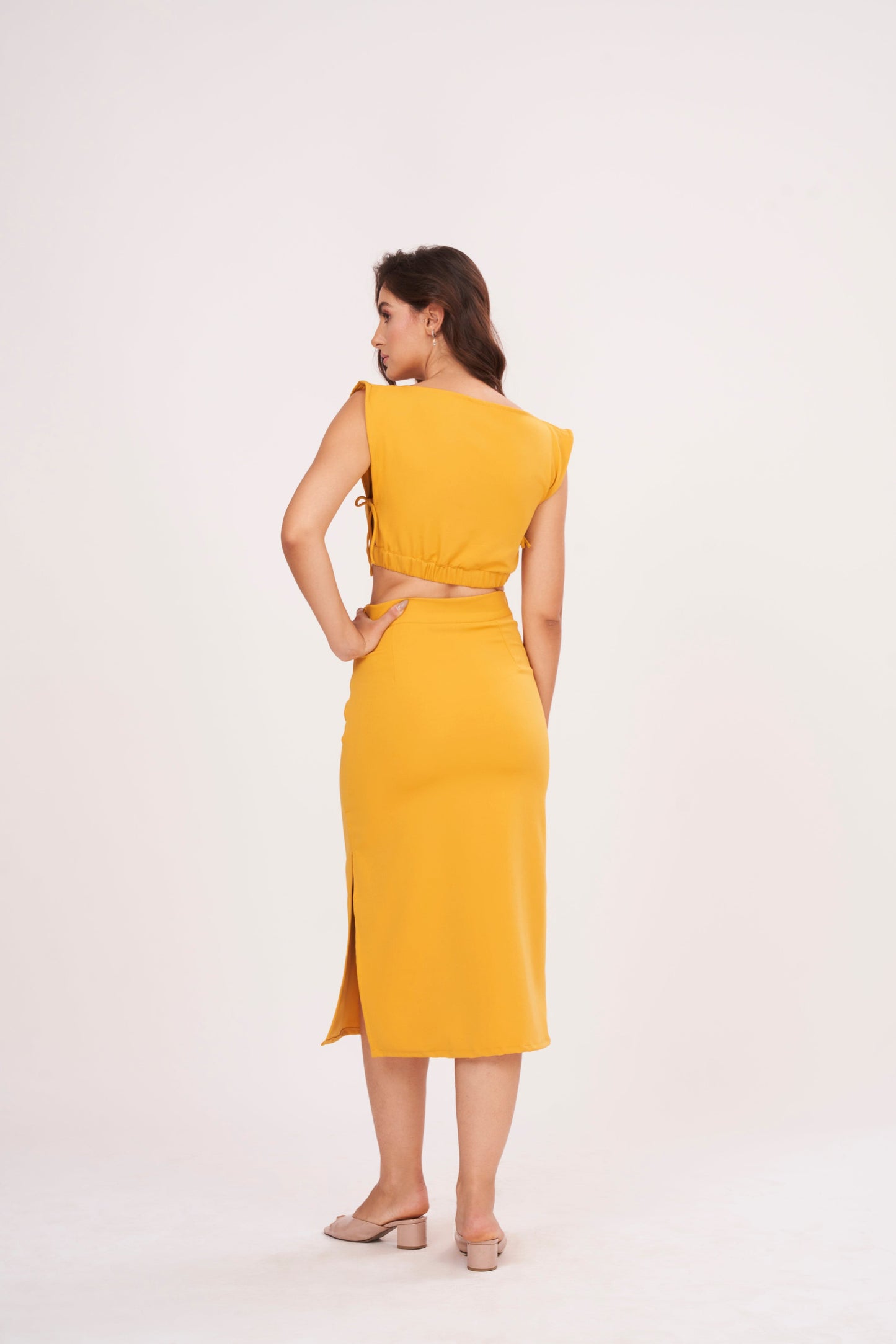 Mustard yellow square neck blouse made from high-quality muslin fabric. Clean and structured silhouette complements the ensemble.