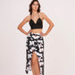 Black halter neck top and floral skirt with captivating front opening and alluring center gap, perfect for beach vacations and showcasing curves.