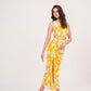 Stylish long skirt with vibrant yellow floral print, perfect for summer. Flattering waist cut creates stunning silhouette, while slit adds touch of elegance. 